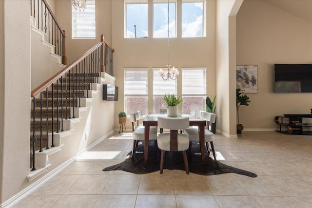 1366 Red Stag Pl, Round Rock, TX 78665 - dining room with a towering ceiling, a chandelier, healthy amount of natural light, stairway, and arched walkways