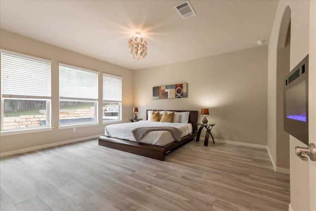 1366 Red Stag Pl, Round Rock, TX 78665 - bedroom featuring wood finished floors and a chandelier