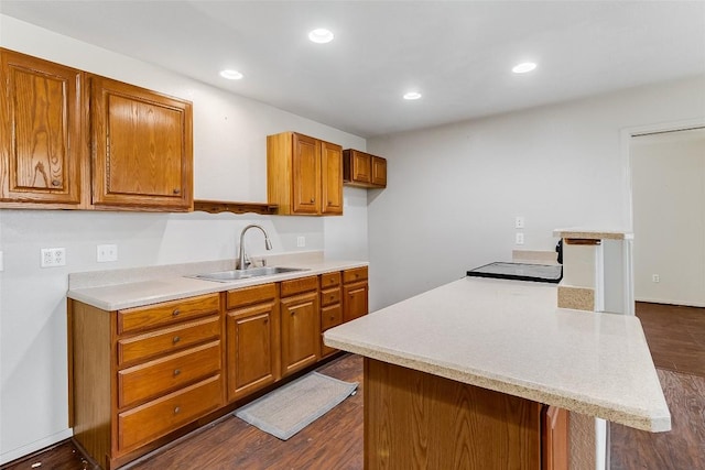 8319 County Road 200, Burnet, TX 78611 - kitchen featuring a sink, light countertops, brown cabinets, dark wood-style flooring, and recessed lighting