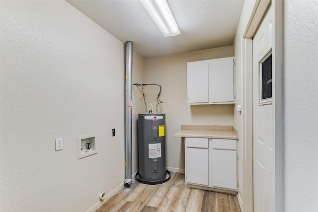 8319 County Road 200, Burnet, TX 78611 - laundry room with electric water heater, cabinet space, washer hookup, light wood-style flooring, and baseboards