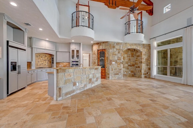 144 Serene St, Spring Branch, TX 78070 - kitchen featuring paneled refrigerator, a high ceiling, stainless steel oven, stone tile floors, and a ceiling fan
