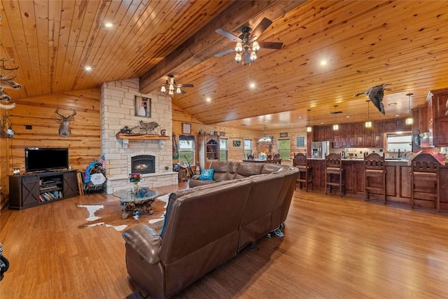 2951 County Road 360, Bartlett, TX 76511 - living room with light wood-type flooring, a stone fireplace, a ceiling fan, wooden ceiling, and a chandelier