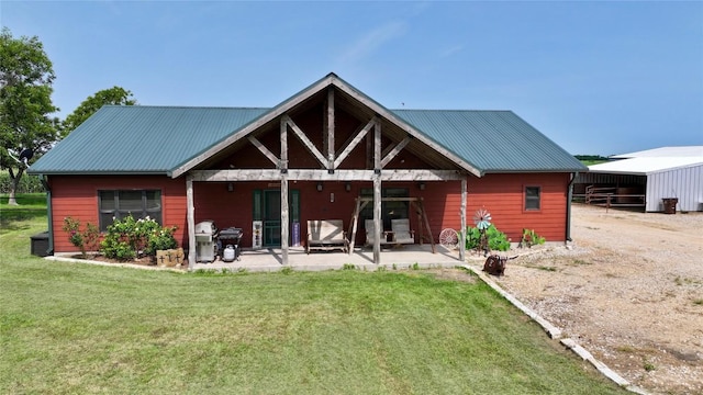 2951 County Road 360, Bartlett, TX 76511 - back of property with a yard, metal roof, and a patio