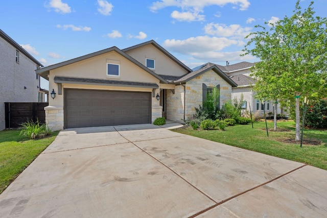 529 Leeward Pass, Leander, TX 78641 - view of front facade featuring stone siding, stucco siding, driveway, and a front lawn