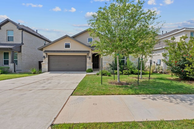 529 Leeward Pass, Leander, TX 78641 - view of front of home with an attached garage, concrete driveway, a front yard, stucco siding, and stone siding