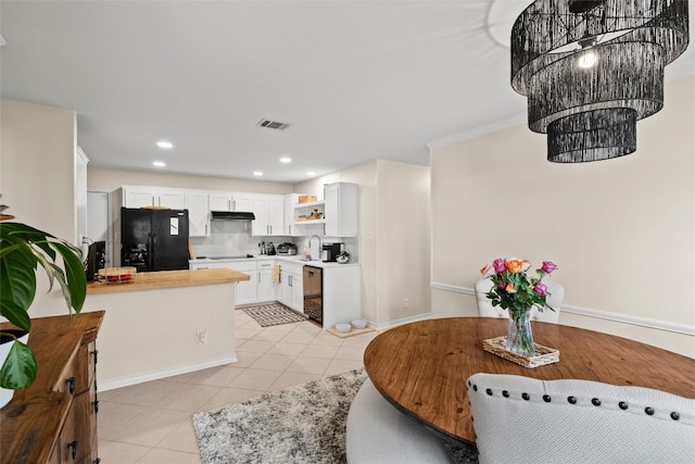 3912 Capistrano Trl, Austin, TX 78739 - kitchen featuring black appliances, light tile patterned floors, light countertops, open shelves, and under cabinet range hood