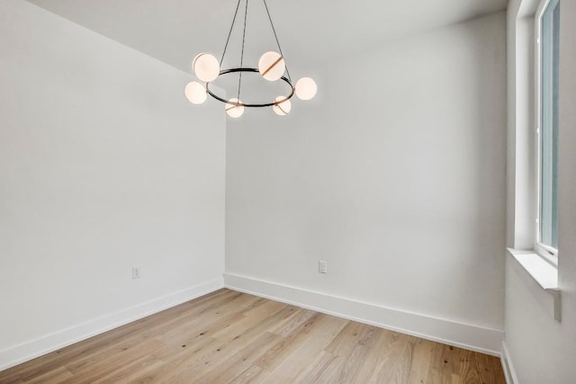 4127 E 12th St Unit 5, Austin, TX 78721 - spare room featuring light wood-type flooring and a chandelier