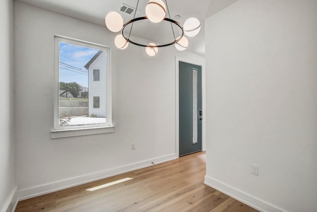 4127 E 12th St Unit 5, Austin, TX 78721 - empty room featuring light wood-style floors and a chandelier