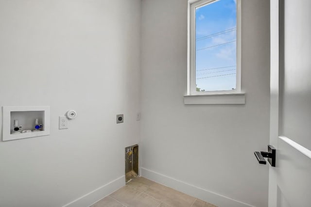 4127 E 12th St Unit 5, Austin, TX 78721 - laundry area featuring hookup for an electric dryer, hookup for a washing machine, light tile patterned flooring, and gas dryer hookup