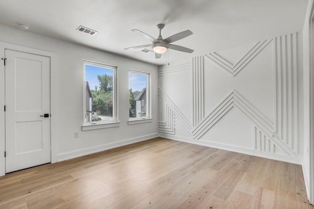 4127 E 12th St Unit 5, Austin, TX 78721 - unfurnished room featuring ceiling fan, a decorative wall, light wood-style floors, and a smoke detector