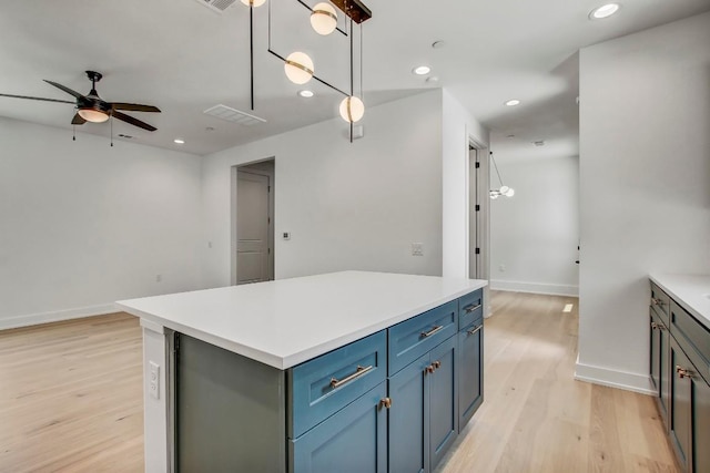 4127 E 12th St Unit 5, Austin, TX 78721 - kitchen with ceiling fan, light wood-style floors, recessed lighting, a center island, and light countertops