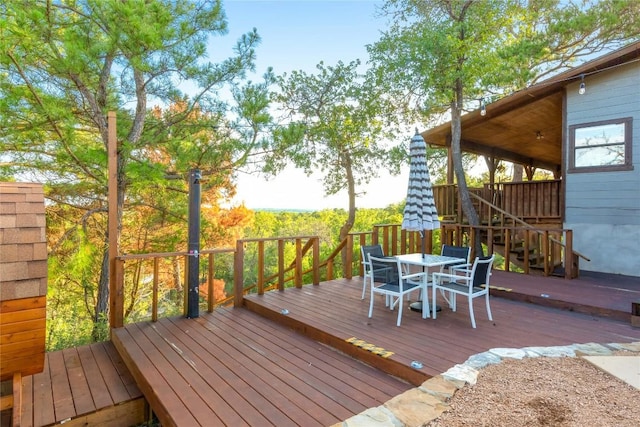 121 Kaelepulu Dr, Bastrop, TX 78602 - wooden deck with outdoor dining space and stairs