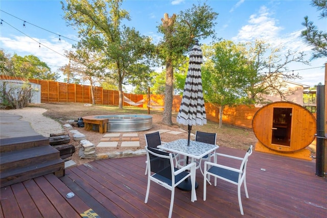 121 Kaelepulu Dr, Bastrop, TX 78602 - deck featuring an outdoor hot tub, a fenced backyard, and outdoor dining space