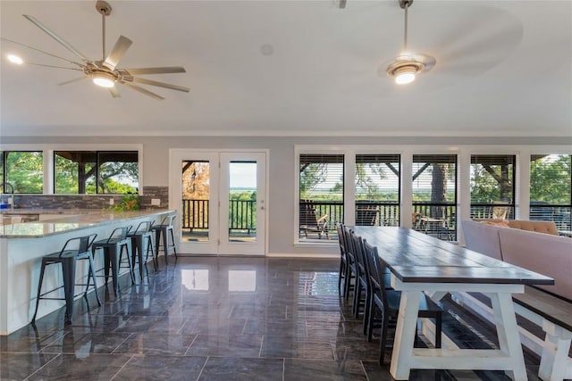 121 Kaelepulu Dr, Bastrop, TX 78602 - dining area featuring healthy amount of natural light, a ceiling fan, crown molding, and dark marble finish flooring