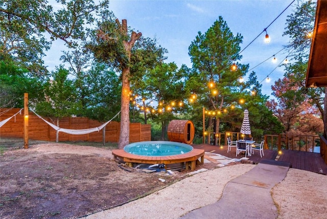 121 Kaelepulu Dr, Bastrop, TX 78602 - fenced backyard featuring an outdoor hot tub and a wooden deck