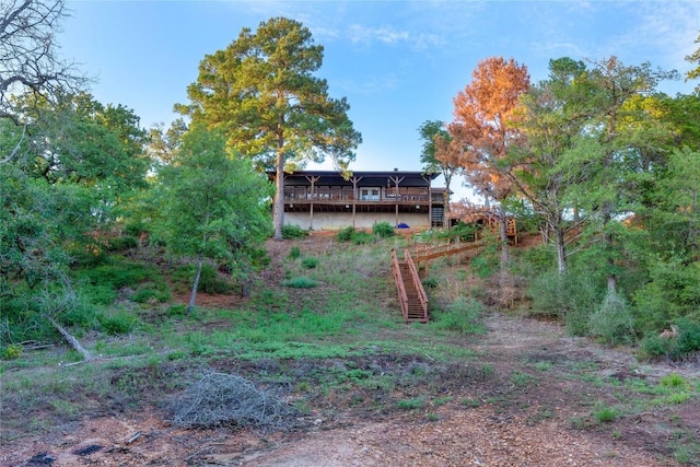 121 Kaelepulu Dr, Bastrop, TX 78602 - view of yard with a wooden deck and stairway