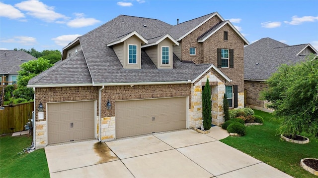 12705 Twisted Root Dr, Manchaca, TX 78652 - view of front of property featuring a shingled roof, concrete driveway, brick siding, stone siding, and a garage