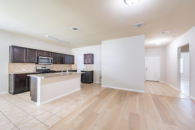 1605 Atlas Rd, Cedar Park, TX 78613 - kitchen with appliances with stainless steel finishes, tasteful backsplash, a center island with sink, and a sink