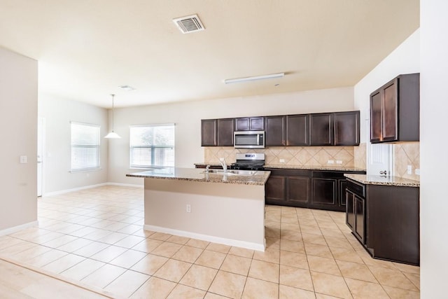 1605 Atlas Rd, Cedar Park, TX 78613 - kitchen featuring appliances with stainless steel finishes, tasteful backsplash, light tile patterned floors, and dark brown cabinets