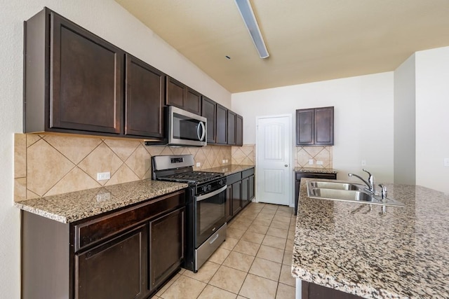 1605 Atlas Rd, Cedar Park, TX 78613 - kitchen with appliances with stainless steel finishes, a sink, decorative backsplash, dark brown cabinets, and light tile patterned flooring