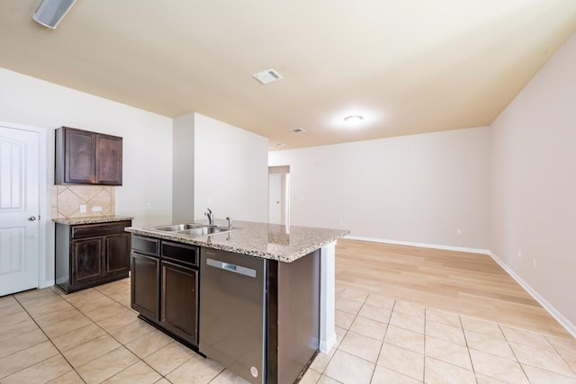 1605 Atlas Rd, Cedar Park, TX 78613 - kitchen featuring dishwasher, a sink, dark brown cabinetry, an island with sink, and light tile patterned floors