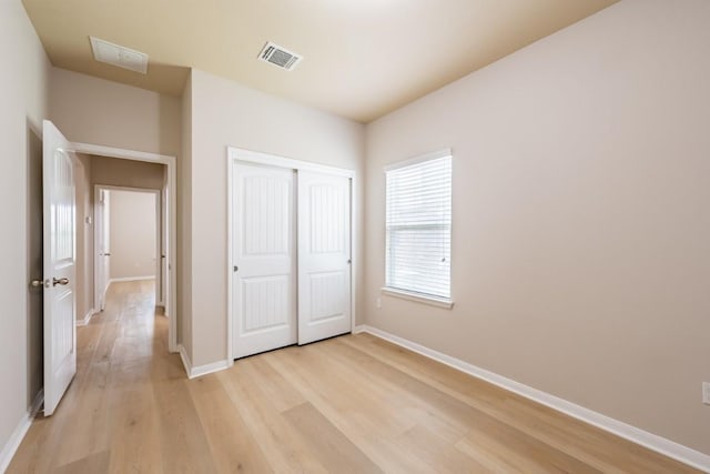 1605 Atlas Rd, Cedar Park, TX 78613 - unfurnished bedroom with light wood-style flooring, baseboards, and a closet
