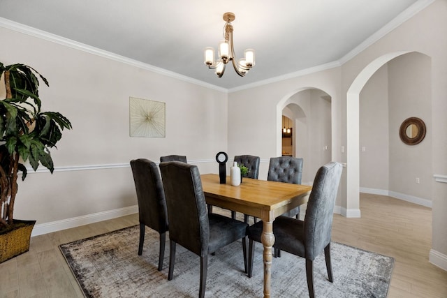 609 Glacial Stream Ln, Cedar Park, TX 78613 - dining room with arched walkways, a chandelier, light wood-style floors, baseboards, and crown molding