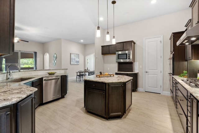 609 Glacial Stream Ln, Cedar Park, TX 78613 - kitchen featuring stainless steel appliances, a sink, dark brown cabinets, decorative light fixtures, and recessed lighting