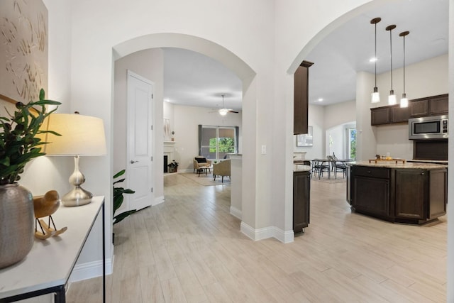 609 Glacial Stream Ln, Cedar Park, TX 78613 - kitchen featuring stainless steel microwave, dark brown cabinets, ceiling fan, light wood-type flooring, and recessed lighting