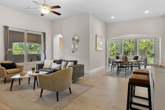 609 Glacial Stream Ln, Cedar Park, TX 78613 - living room with arched walkways, healthy amount of natural light, a ceiling fan, light wood-style flooring, and recessed lighting