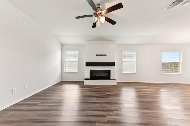 133 Nathaniel Dr, Taylor, TX 76574 - unfurnished living room featuring wood finished floors, ceiling fan, and a glass covered fireplace