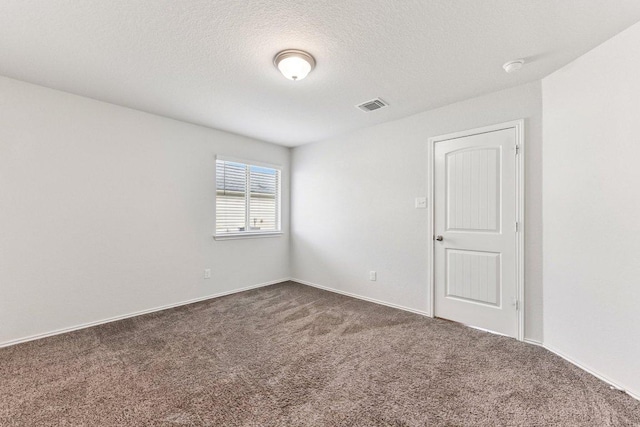 133 Nathaniel Dr, Taylor, TX 76574 - unfurnished room with dark colored carpet, a textured ceiling, and a smoke detector