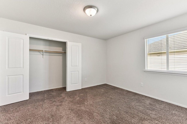 133 Nathaniel Dr, Taylor, TX 76574 - unfurnished bedroom featuring dark colored carpet and a closet