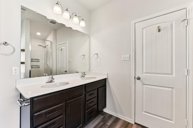 133 Nathaniel Dr, Taylor, TX 76574 - full bath featuring double vanity, a shower, and wood finished floors