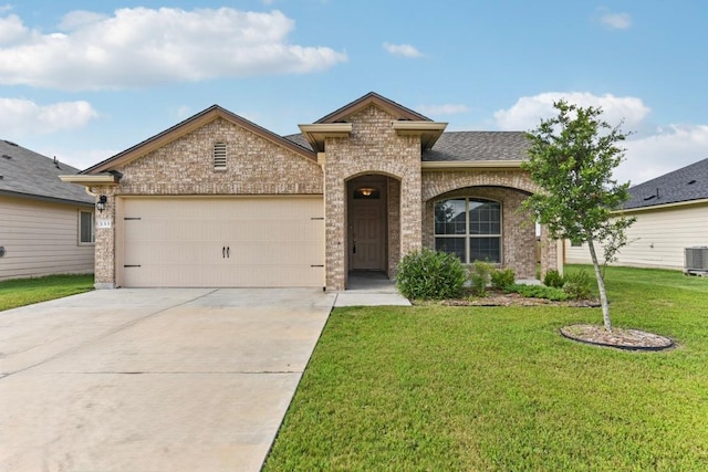 133 Nathaniel Dr, Taylor, TX 76574 - french provincial home featuring brick siding, a front lawn, a garage, driveway, and a shingled roof