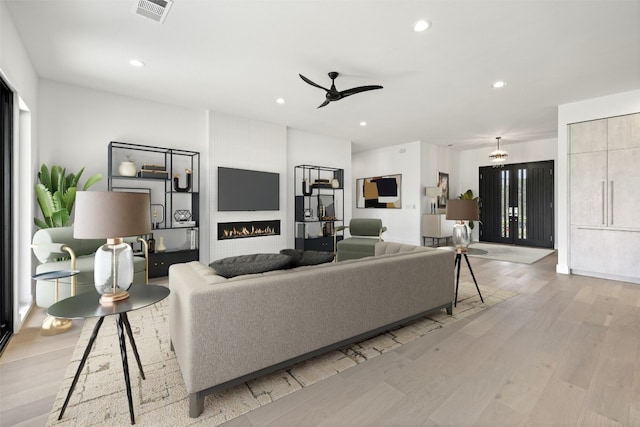 201 Custers Last Stand, Horseshoe Bay, TX 78657 - living room featuring light wood finished floors, recessed lighting, ceiling fan, and a large fireplace