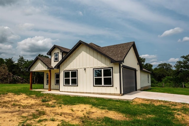 367 Stockade Ranch Rd, Paige, TX 78659 - view of front of house with board and batten siding, a shingled roof, concrete driveway, an attached garage, and a front yard