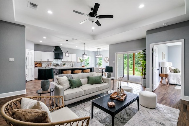 367 Stockade Ranch Rd, Paige, TX 78659 - living room with wood finished floors, a tray ceiling, recessed lighting, baseboards, and ceiling fan