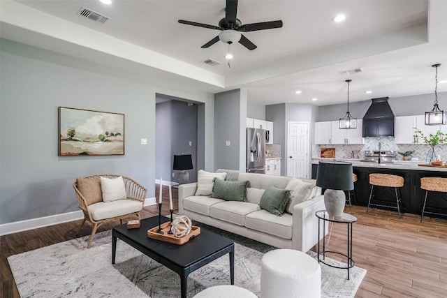 367 Stockade Ranch Rd, Paige, TX 78659 - living area featuring baseboards, light wood-style flooring, recessed lighting, ceiling fan, and a raised ceiling