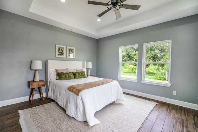367 Stockade Ranch Rd, Paige, TX 78659 - bedroom with a raised ceiling, baseboards, recessed lighting, wood finished floors, and a ceiling fan