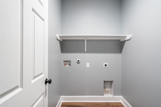 367 Stockade Ranch Rd, Paige, TX 78659 - laundry area with hookup for an electric dryer, hookup for a gas dryer, baseboards, wood finished floors, and hookup for a washing machine