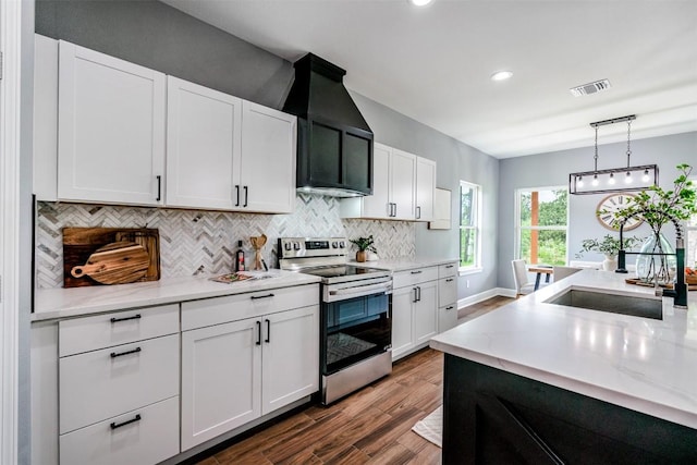 367 Stockade Ranch Rd, Paige, TX 78659 - kitchen with stainless steel electric range, dark wood finished floors, tasteful backsplash, white cabinetry, and recessed lighting