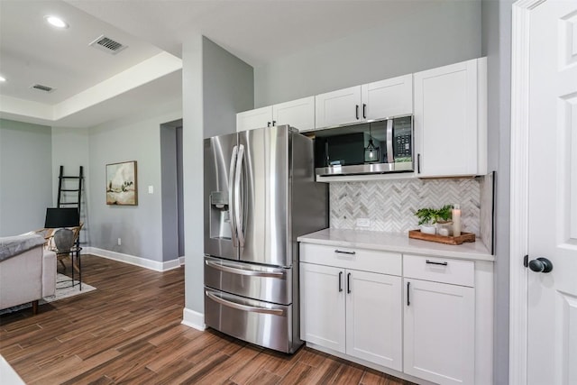 367 Stockade Ranch Rd, Paige, TX 78659 - kitchen with appliances with stainless steel finishes, tasteful backsplash, dark wood finished floors, light countertops, and white cabinets