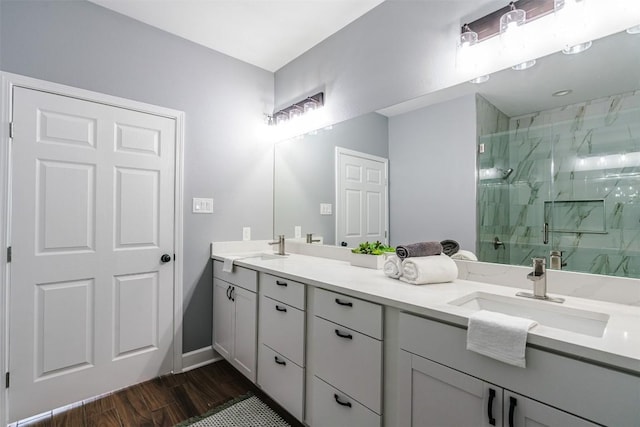367 Stockade Ranch Rd, Paige, TX 78659 - bathroom featuring a marble finish shower, double vanity, wood finished floors, and baseboards