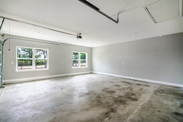 367 Stockade Ranch Rd, Paige, TX 78659 - garage featuring baseboards and a garage door opener