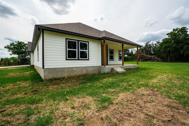 367 Stockade Ranch Rd, Paige, TX 78659 - back of house with a lawn, covered porch, and a shingled roof