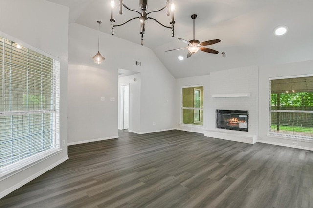 501 Maple Run, Round Rock, TX 78664 - unfurnished living room with vaulted ceiling, dark wood-type flooring, ceiling fan, a brick fireplace, and baseboards