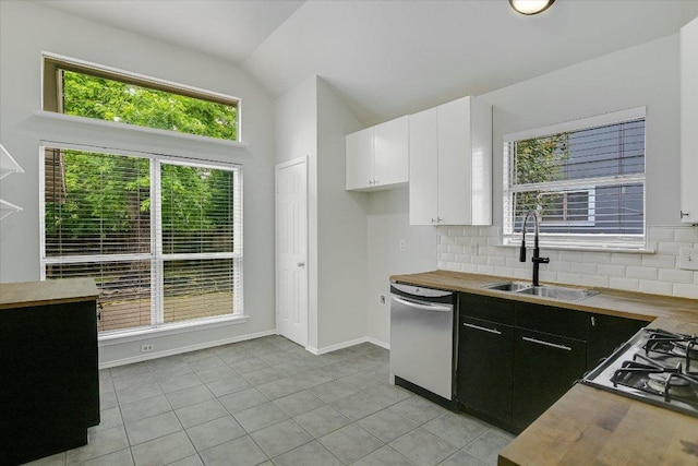 501 Maple Run, Round Rock, TX 78664 - kitchen with stainless steel dishwasher, a sink, butcher block countertops, vaulted ceiling, and backsplash