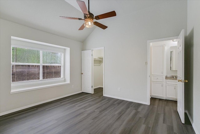 501 Maple Run, Round Rock, TX 78664 - unfurnished bedroom with dark wood-type flooring, high vaulted ceiling, baseboards, a spacious closet, and ensuite bathroom