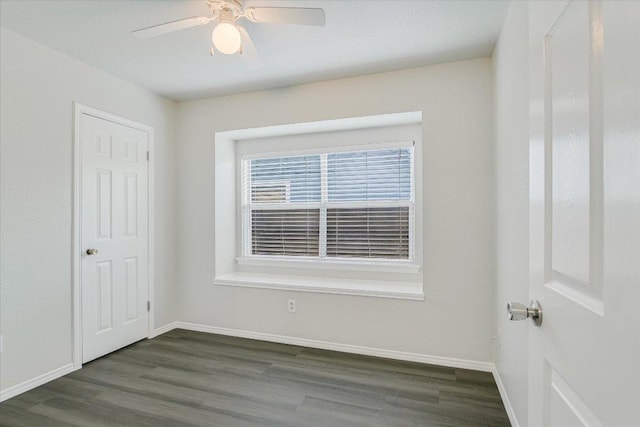 501 Maple Run, Round Rock, TX 78664 - spare room featuring dark wood-type flooring, baseboards, and a ceiling fan